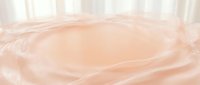 Smooth beige liquid swirls creating an abstract cosmetic or skincare product background with soft peachy tones, suitable for beauty and wellness branding.