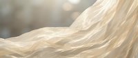 Flowing blonde hair with soft waves and natural highlights, captured in motion with warm, diffused lighting and blurred background for beauty and cosmetics use.