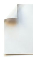 Rolled white paper sheet with curled corner and shadow detail on clean background for design and printing projects.