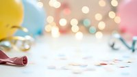 Colorful party celebration background with confetti, balloons and festive bokeh lights creating magical atmosphere for birthday events and holidays.
