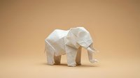 White origami elephant paper craft on beige background showcasing traditional Japanese folding art technique for creative projects and decorations.