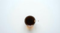 Cup of black coffee on white background isolated for morning beverage design and cafe marketing materials.