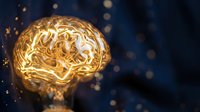 Golden glowing brain with neural pathways and circuits on dark blue background with bokeh lights for technology and artificial intelligence concepts.