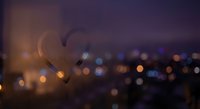 Heart shape silhouette against blurred city lights bokeh background at night creating romantic atmosphere for Valentine's Day celebrations and love concepts.