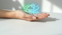 Hand holding glowing neon weather forecast icon with lightning and cloud symbols, representing meteorology, climate prediction, and digital weather technology solutions.