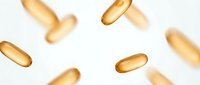 Golden vitamin capsules floating on white background for health supplement marketing and wellness product design.