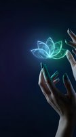 Hands holding glowing neon lotus flower with blue and green light effects on dark background for wellness, spirituality, meditation, and healing concepts.
