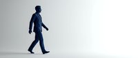 Professional businessman walking forward in confident stride against clean white background for business presentations and corporate materials.