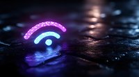 Glowing neon wifi symbol in pink and blue colors on dark reflective wet surface with bokeh lights and water drops creating moody atmosphere.