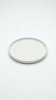 Empty white ceramic plate isolated on white background for food presentation and kitchen design projects.