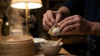 Senior chef hands kneading fresh pasta dough in warm kitchen lighting. Traditional cooking techniques for authentic homemade Italian cuisine preparation.