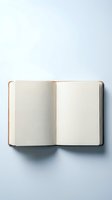 Open blank notebook with cream pages on white background for writing, journaling, planning and creative projects.