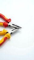 Professional electrician pliers with insulated handles on white background for electrical work and repair projects.