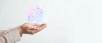 Hand holding glowing infinity symbol representing endless possibilities, eternal love, and unlimited potential for business and personal growth concepts.
