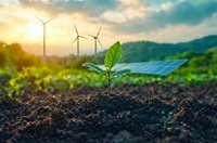 Green plant seedling growing from soil with wind turbines and solar panels in background representing sustainable renewable energy and environmental growth.