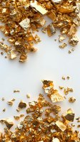 Scattered gold leaf fragments and metallic foil pieces creating luxurious border composition on white background. Suitable for luxury product designs and festive decorations.