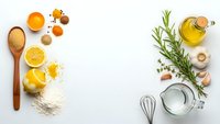 Cooking ingredients flat lay with fresh herbs, spices, olive oil, garlic, lemon and kitchen utensils on white background for culinary recipes and food preparation.