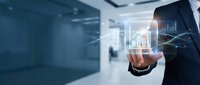 Businessman in dark suit touching holographic financial charts and growth graphs in modern office environment for business analytics and data visualization concepts.