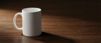 White ceramic coffee mug on wooden table with warm lighting and shadow, mockup template for custom designs and branding applications.