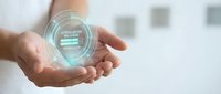 Male hand holding glowing digital hologram sphere with data visualization interface, representing technology innovation, business solutions, and futuristic digital transformation concepts.