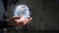 Young male professional holding transparent sphere with digital data layers, representing technology innovation, cloud computing, and business solutions for corporate presentations and tech industry marketing.