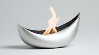 Modern silver metal fire bowl with dancing flame on neutral background for contemporary home decor and heating solutions.