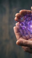 Hand holding glowing purple digital sphere with interconnected network nodes and gear symbols, representing technology, innovation, and digital transformation concepts.