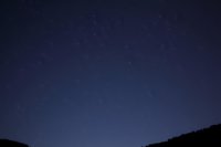 Night sky with stars over silhouetted hills creating peaceful astronomy backdrop for stargazing and celestial observation projects.