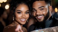 Young African American couple smiling at celebration event, dressed elegantly with sparkling bokeh lights in background, expressing joy and romance.