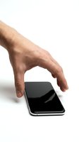 Male hand with light skin tone reaching toward smartphone with black screen on white background, isolated for app design and technology marketing use.