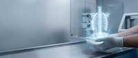 Medical professional examining holographic spine model on tablet in modern healthcare facility for diagnostic and educational purposes.