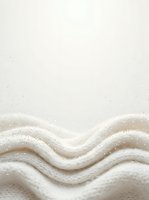 Soft cream-colored fabric with undulating waves and subtle sparkle details, isolated on neutral background. Suitable for textile, fashion, and design projects.