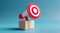 Red and white megaphone on wooden block against blue background, symbolizing marketing, communication, and announcement concepts for business presentations.