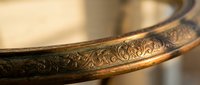 Ornate bronze bowl with intricate floral engravings and decorative patterns showcasing traditional metalwork craftsmanship and antique styling for luxury decor.