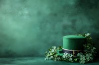 Green leprechaun hat with shamrock decorations on dark emerald background with copy space for St Patrick's Day celebration or Irish holiday design.