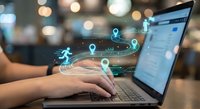 Hands typing on laptop with digital analytics icons and data visualization overlay in modern office environment for business technology concepts.