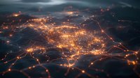 Glowing orange network connections and city lights viewed from above create abstract pattern against dark background. Futuristic technology concept for business.