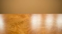 Wooden floor with warm sunlight casting natural shadows, showcasing polished oak or similar hardwood surface for interior design and home decor projects.