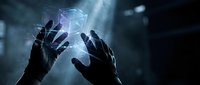 Hands reaching toward glowing holographic cube in dark atmospheric setting with dramatic lighting for futuristic technology concepts.