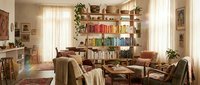 Cozy living room interior with colorful bookshelf, comfortable armchairs, wooden coffee table, warm lighting and plants creating inviting reading space.