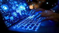 Hands typing on illuminated keyboard with glowing blue technology icons and digital interface display in dark background, representing cybersecurity and data analysis.