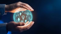 Businessman hands protecting glowing digital innovation sphere with lightbulb and technology icons on dark blue background for business concepts.