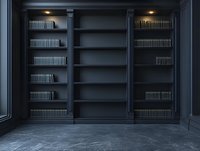 Dark elegant built-in bookshelf with black wooden panels and empty shelves illuminated by soft overhead lighting against textured stone floor in luxury interior.