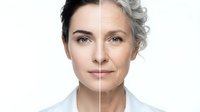 Split-face portrait showing aging process from young to mature woman with dark and gray hair on white background for skincare and beauty concepts.