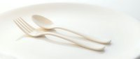 Eco-friendly biodegradable wooden cutlery set with fork and spoon on white background, sustainable dining utensils for zero waste lifestyle.