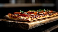 Fresh baked pizza with melted cheese, pepperoni and herbs served on rustic wooden board, close-up view with selective focus and dark background.