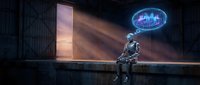 Futuristic robot sitting alone in dark industrial warehouse with glowing holographic city display above, contemplating urban planning and artificial intelligence.