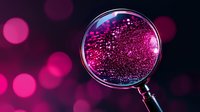 Magnifying glass revealing sparkling pink bokeh lights against dark background, creating magical scientific exploration atmosphere for research concepts.