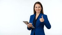 Professional businesswoman in blue suit holding tablet showing thumbs up gesture on white background for corporate presentations and marketing materials.