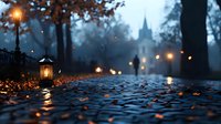 Atmospheric cobblestone path in foggy autumn park with vintage lanterns and distant church silhouette at dusk.